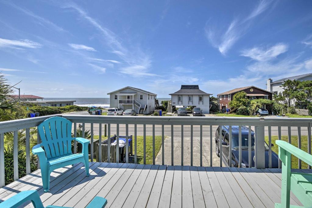 a deck with two chairs and a view of the ocean at Oak Island Beach Abode with Deck Walk to Shore! in Oak Island