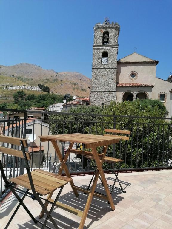 a wooden picnic table and chairs on a patio at La Rocca dei Borboni in Santa Domenica Talao