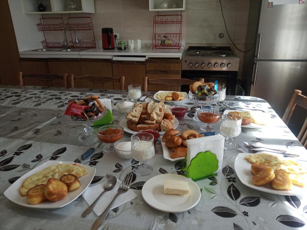 a table with plates of food on it at Meerim Guest House in Bokonbayevo