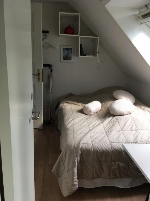 a bedroom with a bed with two pillows on it at Nationalpark Thy guesthouse in Vestervig