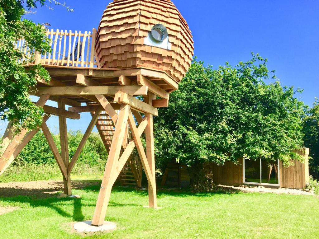 a tree house sitting on top of a grass field at Nuit insolite Lovelit Val André in Pléneuf-Val-André