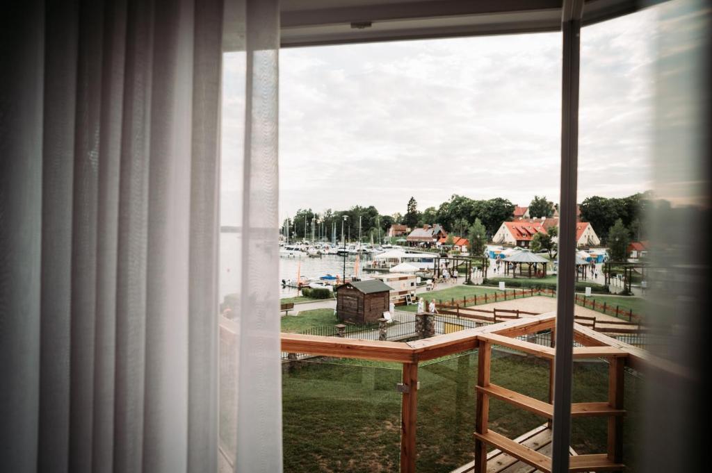 a view of a marina from a window at Willa Z Widokiem na Jezioro in Ryn