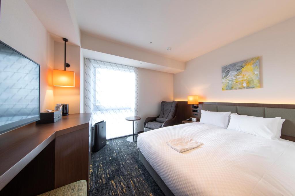 Postel nebo postele na pokoji v ubytování Hotel Forza Nagoya Sakae
