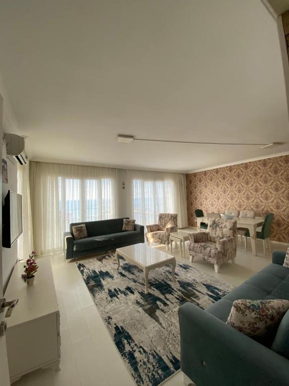 a large living room with couches and a rug at sunset villa in Cimenli