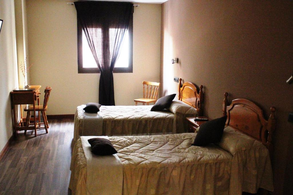 Posteľ alebo postele v izbe v ubytovaní Hostal Extremeño