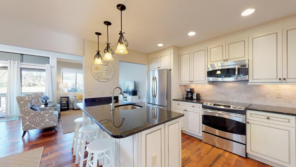 a kitchen with white cabinets and a counter top at 284 Turnberry Village in Hilton Head Island