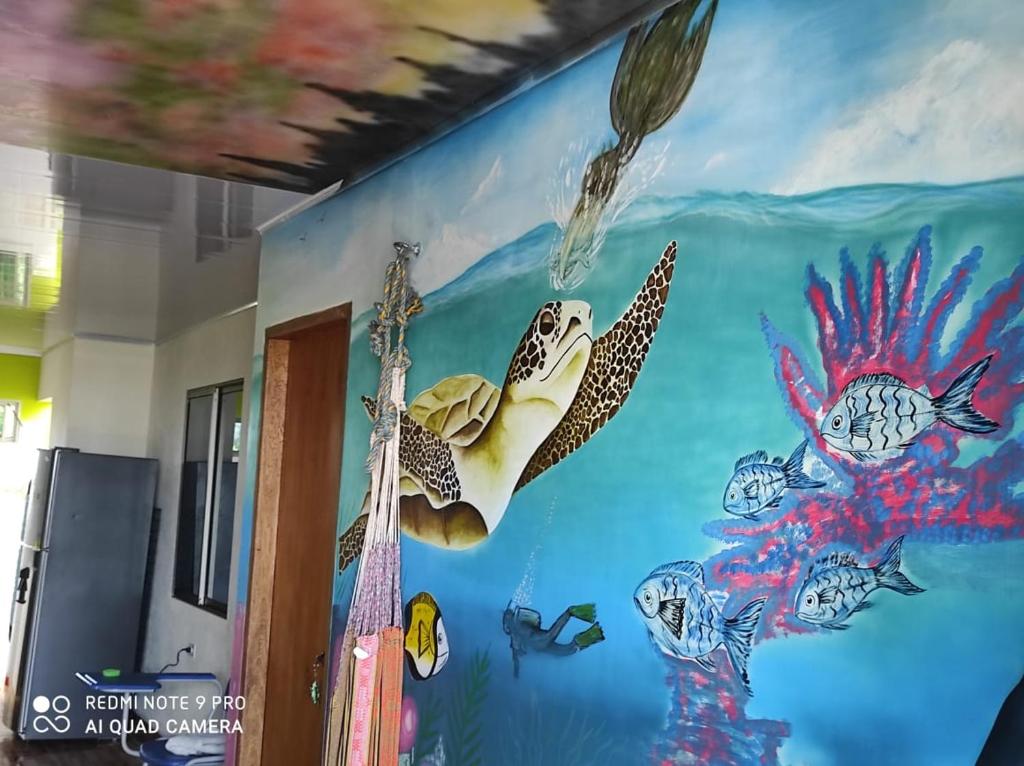 a room with a sea turtle mural on the wall at Hostal mis dos ángeles in Santiago