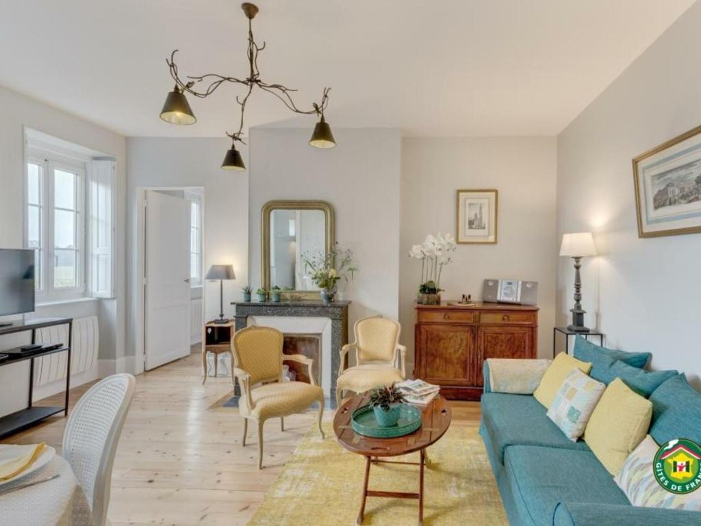 a living room with a blue couch and a table at Appartement Chantilly, 3 pièces, 4 personnes - FR-1-526-3 in Chantilly