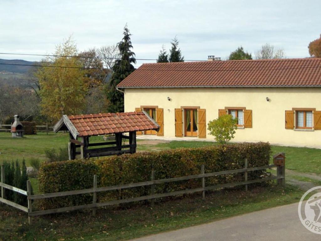 a house with a red roof and a fence at Gîte La Tuilière, 4 pièces, 6 personnes - FR-1-496-93 in Saint-Priest-la-Prugne