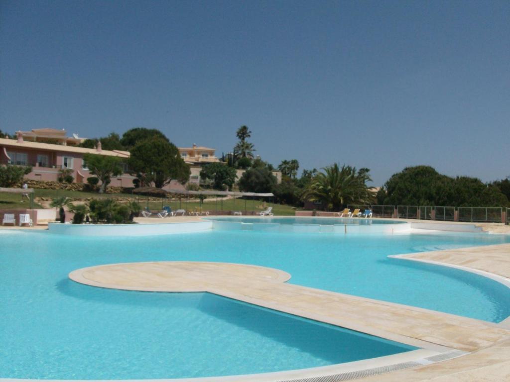 a large swimming pool with blue water at Belver Porto Dona Maria Resort in Luz