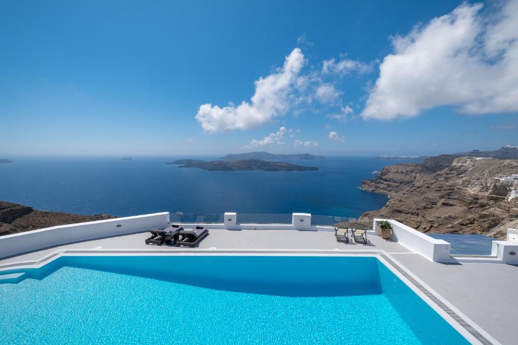 a swimming pool with a view of the ocean at Argento Nero in Fira