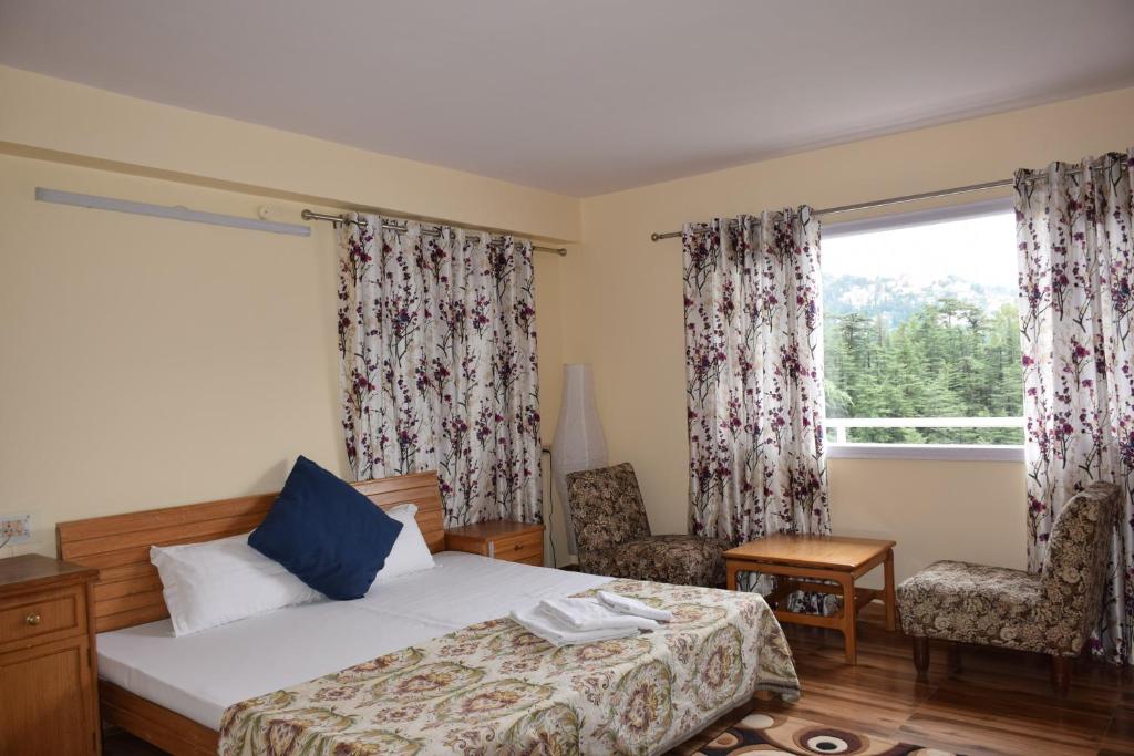 Postel nebo postele na pokoji v ubytování Vatsalyam Home Stay