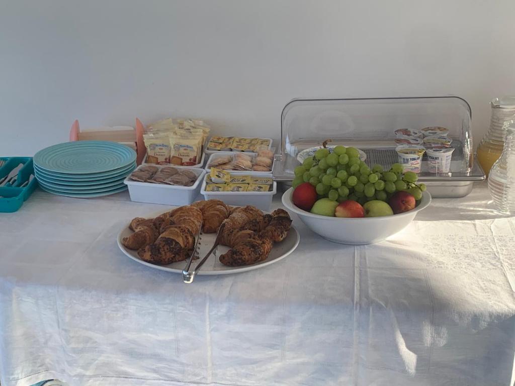 a table topped with plates of food and bowls of fruit at Miriasol Bed and Breakfast in Capo Vaticano