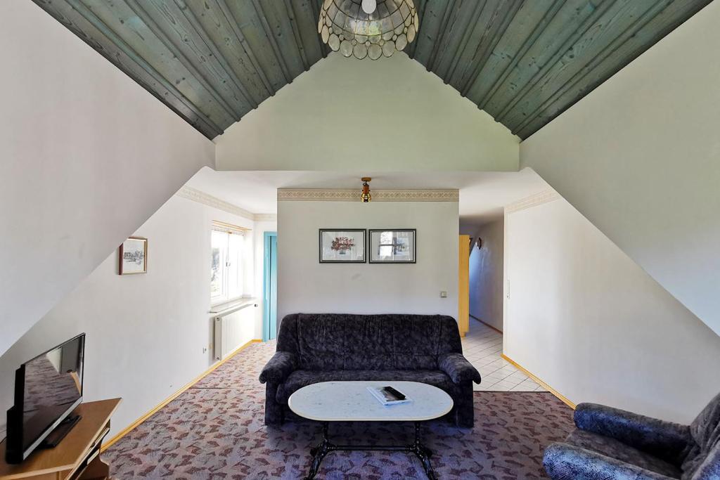 a living room with a couch and a table at Landhaus zur Schmiede in Abtsroda