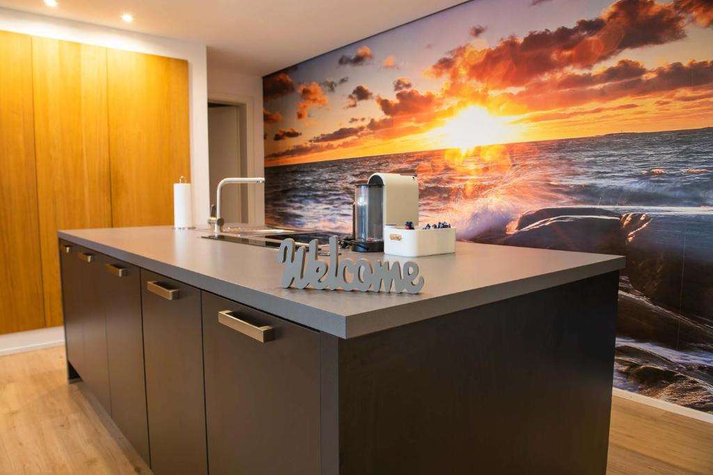 a kitchen with a large painting on the wall at The City Suite - Luxuswohnung in Kempten