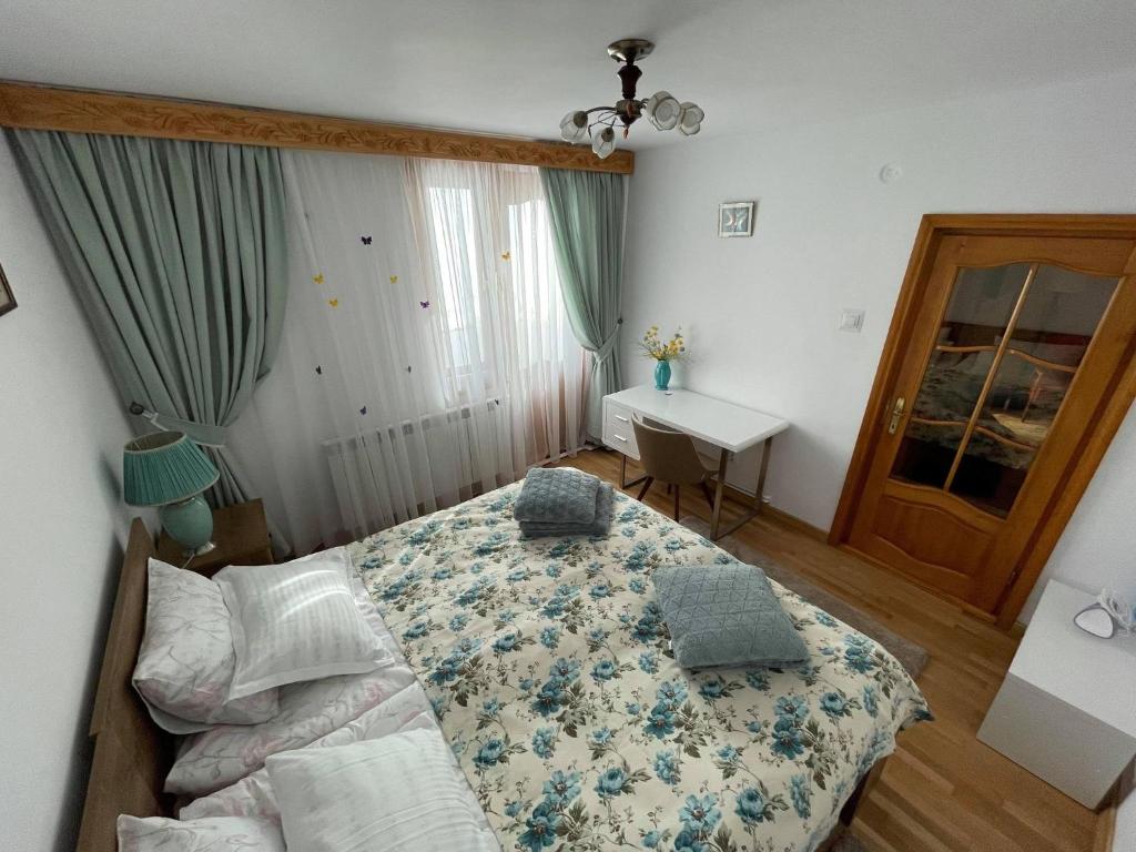 a bedroom with a bed and a desk in it at Like Home - Cozy & Quite in Piatra Neamţ
