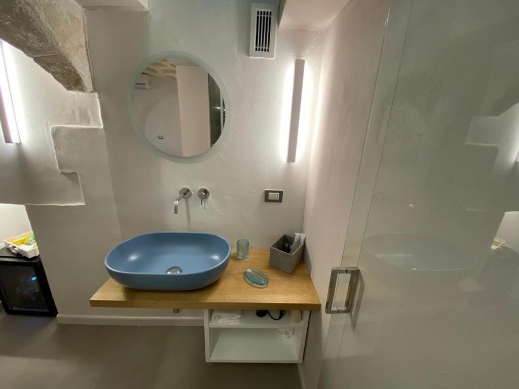 a bathroom with a blue sink and a mirror at Sogno D'Epoca 1822 in Monopoli