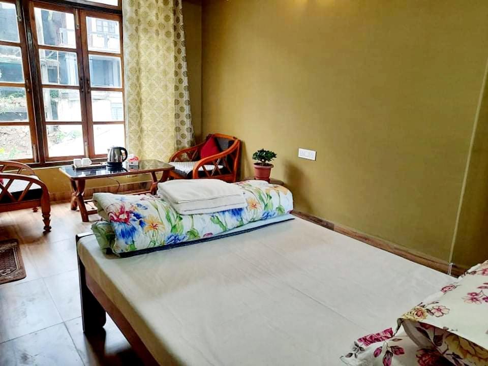 Postel nebo postele na pokoji v ubytování Kalimpong Sunrise-Inn Homestay