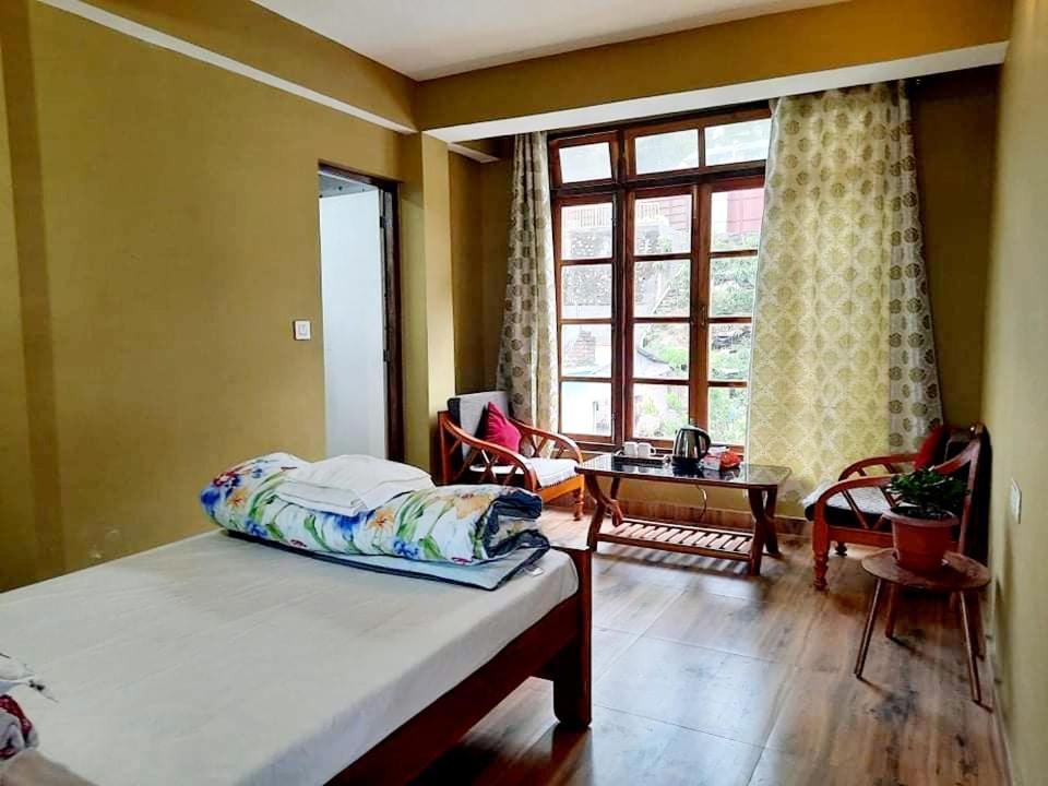 Postel nebo postele na pokoji v ubytování Kalimpong Sunrise-Inn Homestay