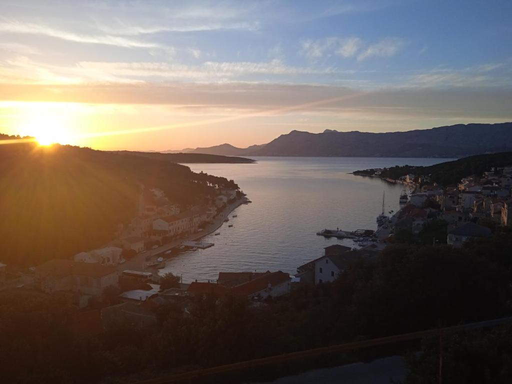 a sunset over a city and a body of water at Anton in Povlja