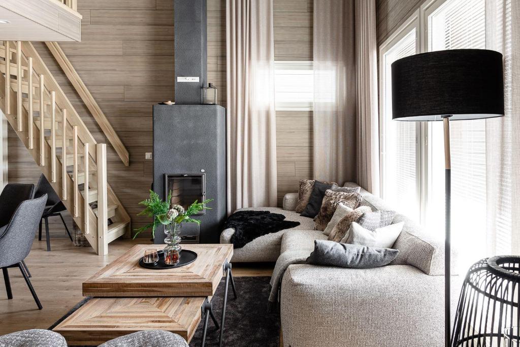 a living room with a couch and a fireplace at Syötteenwalo in Syöte