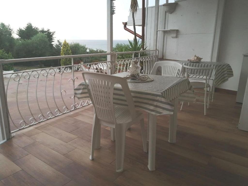 a table and chairs on a balcony with a view at Villa Paradiso in Gaeta