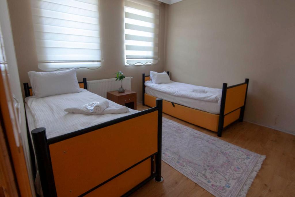 Postel nebo postele na pokoji v ubytování Sevin Stone Hotel