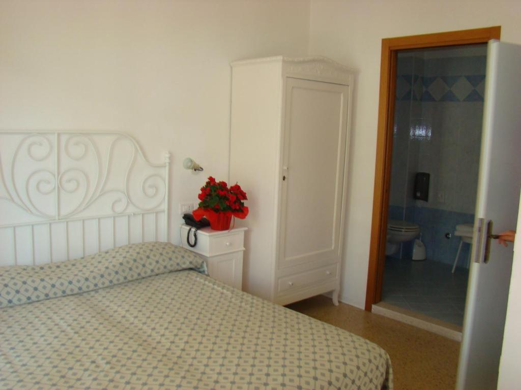 Postel nebo postele na pokoji v ubytování Hotel Tizian Beach