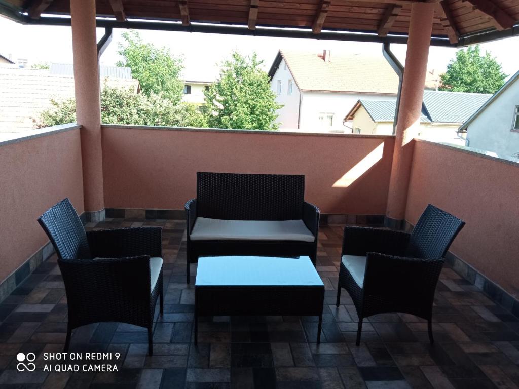 a patio with chairs and a table on a balcony at Apartment LIKA in Gospić