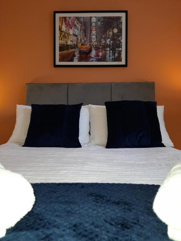 a bed with black and white pillows in a room at Ideal Apartment - Sleeps 6 - Parking in Barnsley