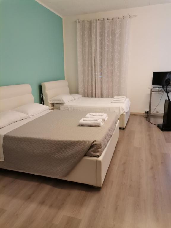 Posteľ alebo postele v izbe v ubytovaní B&B Porto Vecchio ROOMS - Stazione Centrale Trieste