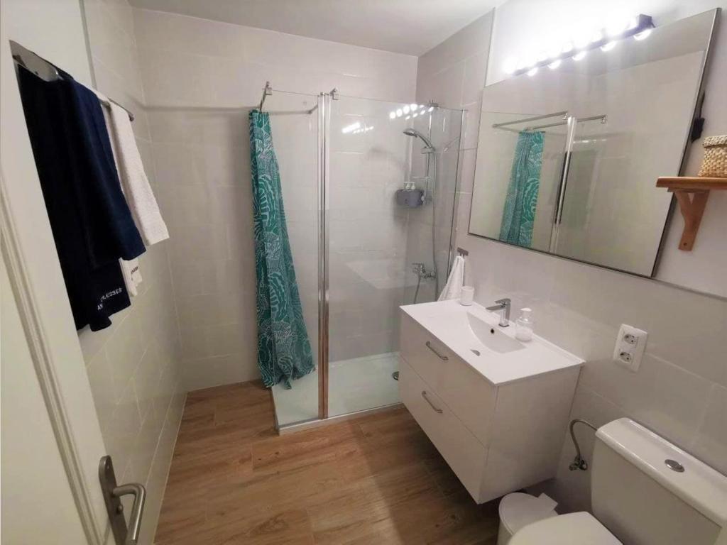 a white bathroom with a shower and a sink at Casa La Cañada in La Orotava