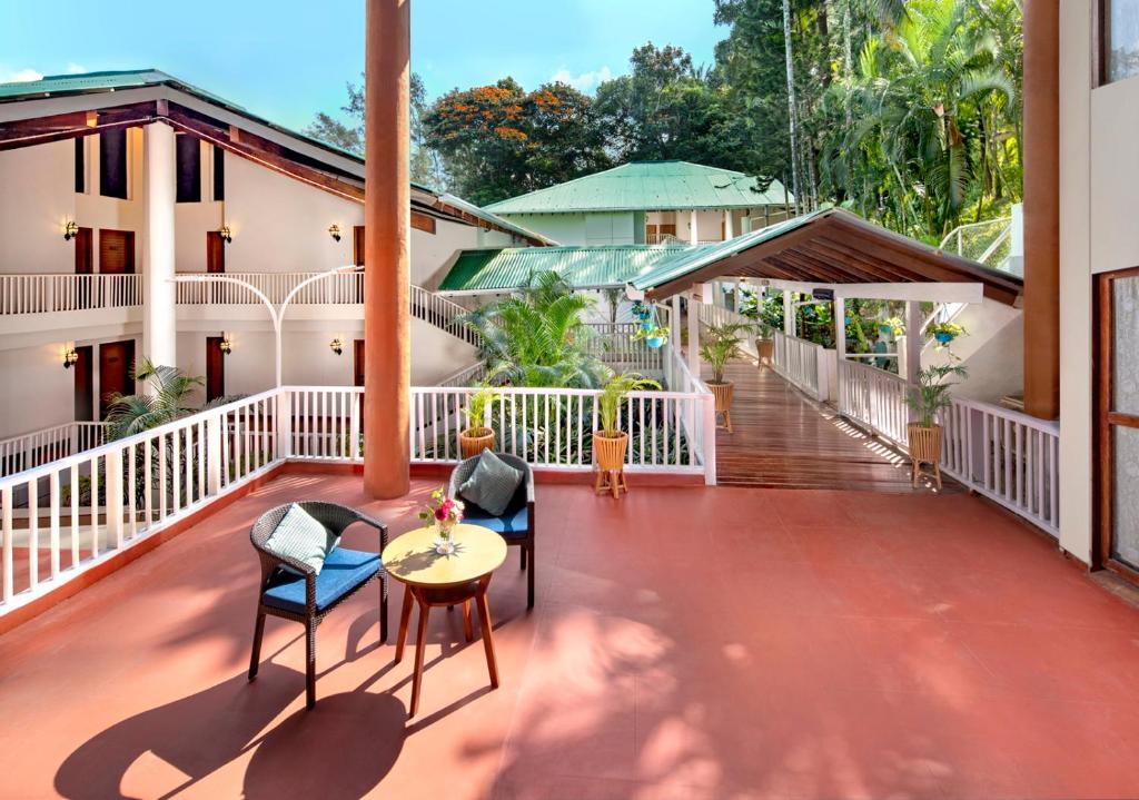 a balcony of a house with chairs and a table at Welcomhotel by ITC Hotels, Bay Island, Port Blair in Port Blair