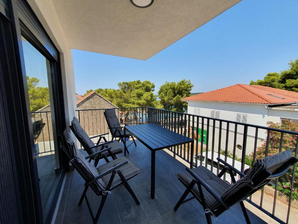 a balcony with a table and chairs on it at Apartmani Nerium in Lovište