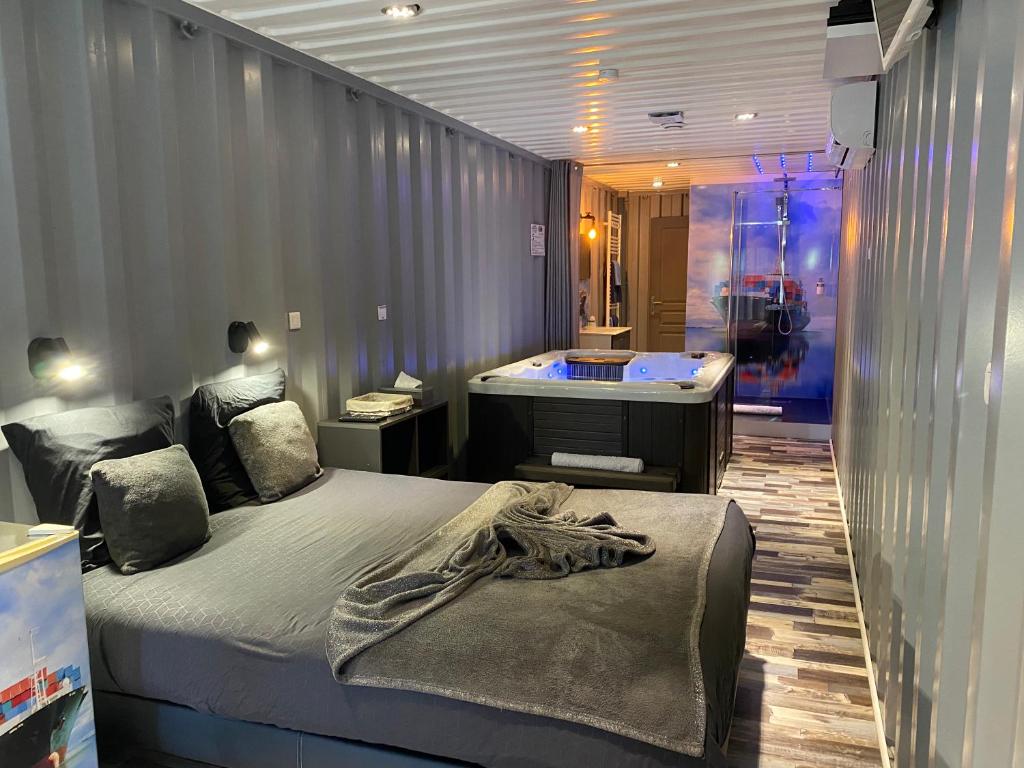 um quarto com 2 camas e uma banheira em Les Docks Insolite & SPA em Berck