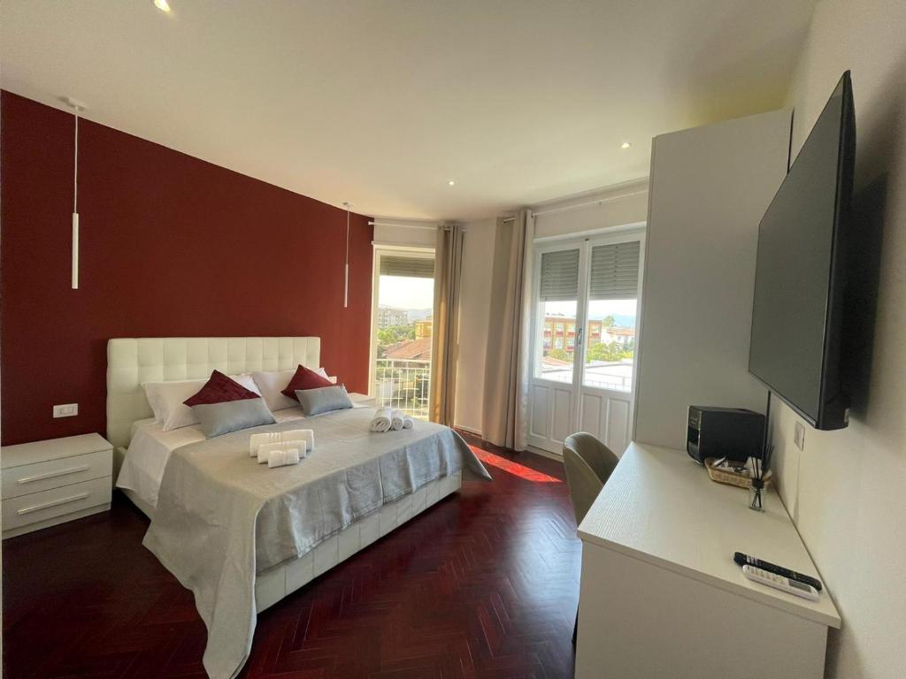 a bedroom with a bed and a flat screen tv at Nature Room in Olbia