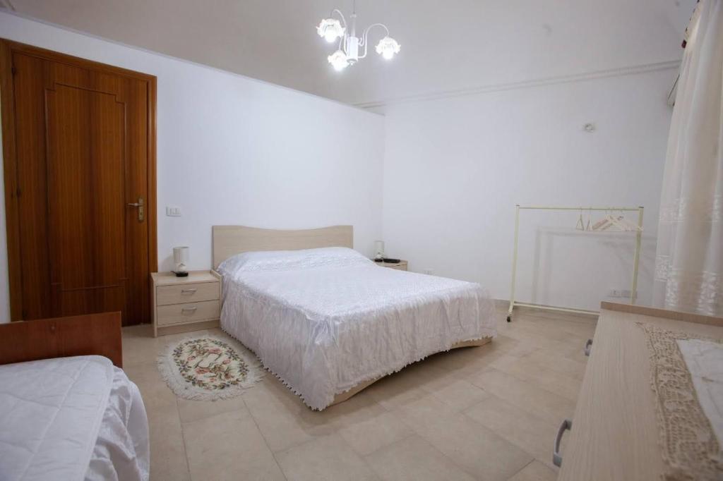 Łóżko lub łóżka w pokoju w obiekcie Casa Terranova Modica