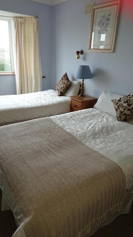 Postel nebo postele na pokoji v ubytování Seashore Lodge Guesthouse