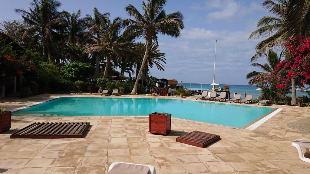 a swimming pool with a view of the ocean at Porto Antigo 2 in Santa Maria