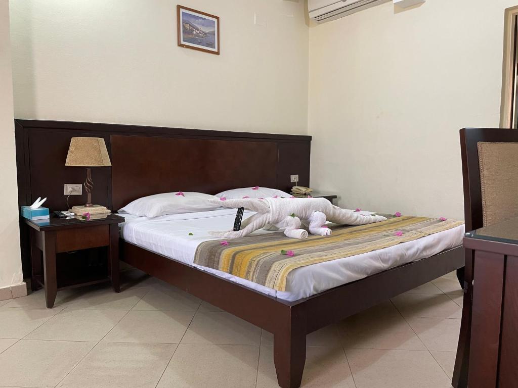 Postel nebo postele na pokoji v ubytování Naama Inn Hotel