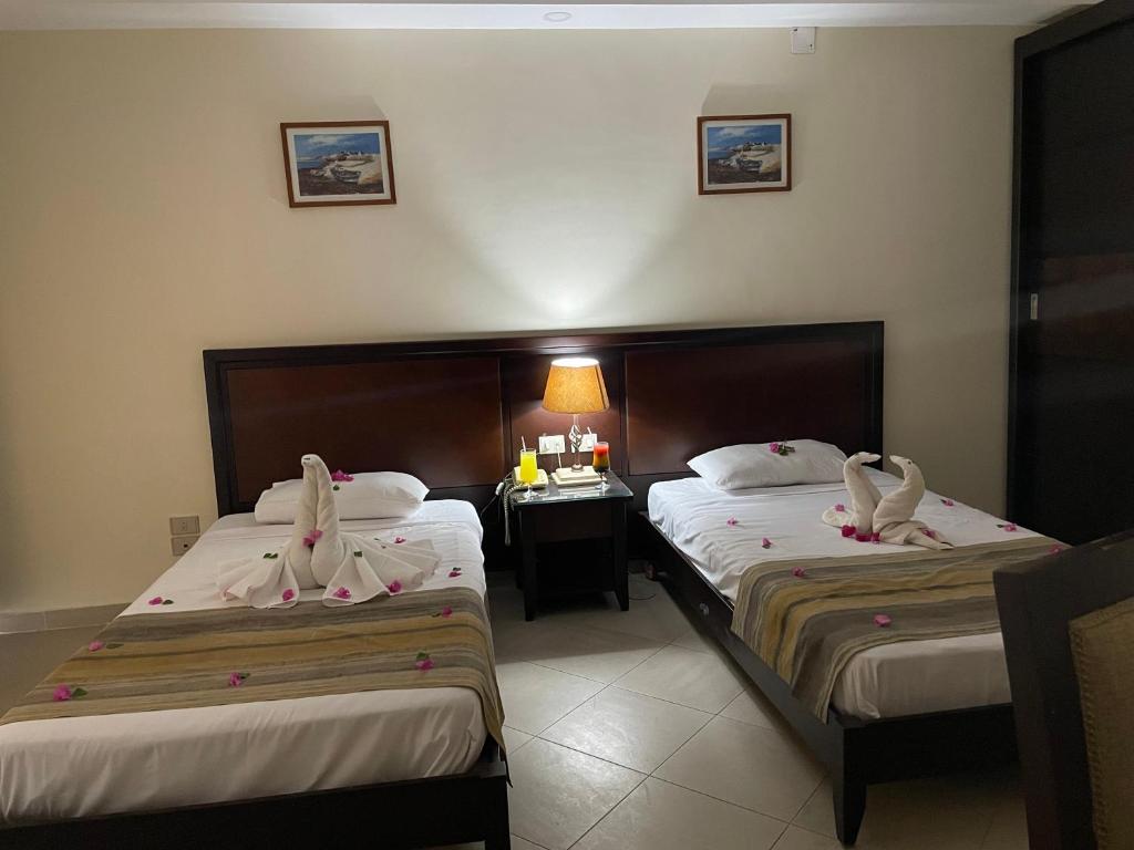 Postel nebo postele na pokoji v ubytování Naama Inn Hotel
