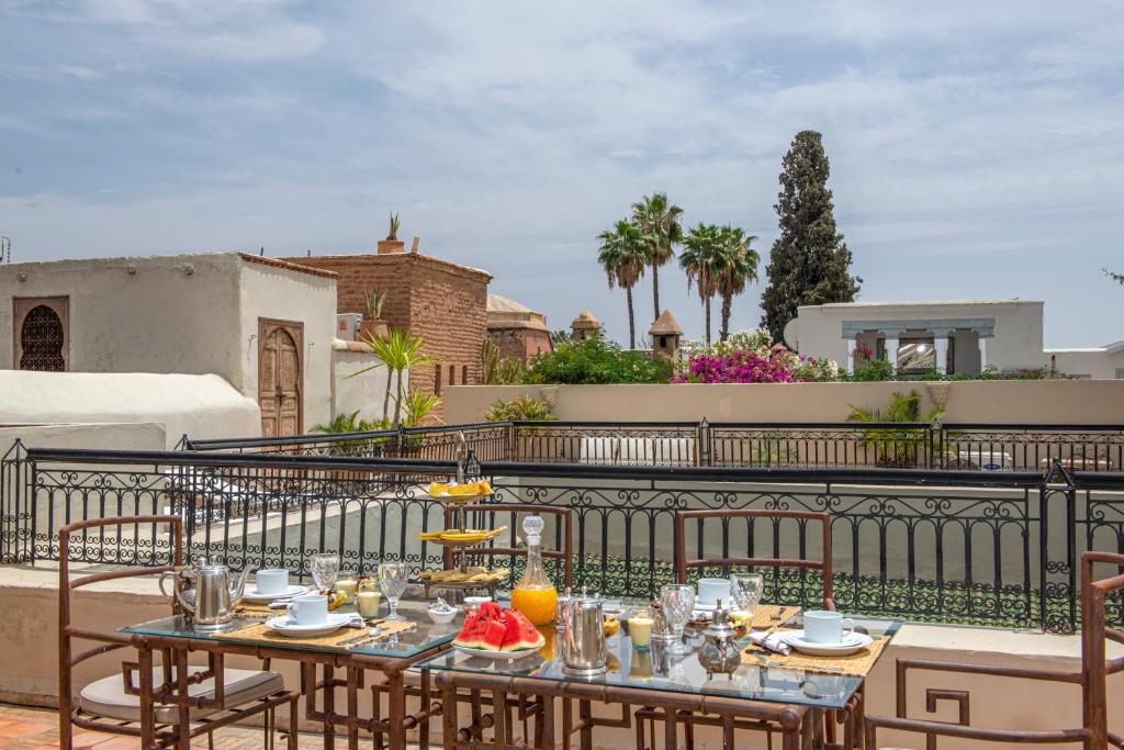 a table with food on top of a balcony at Riad Zhor in Marrakesh