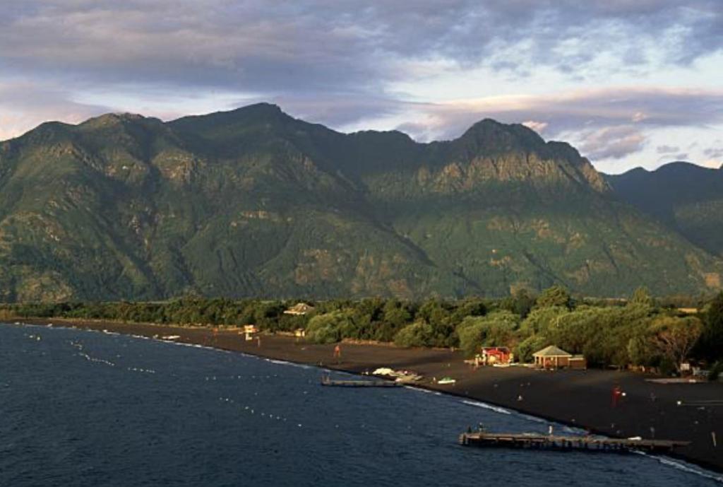 a view of a beach with mountains in the background at Pucon, la Capital del Sur de Chile in Pucón