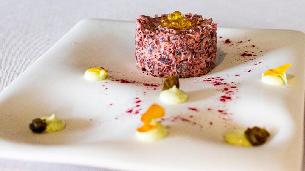 a white plate with a pink dessert on it at Hotel Gastronómico Torre de Galizano in Galizano