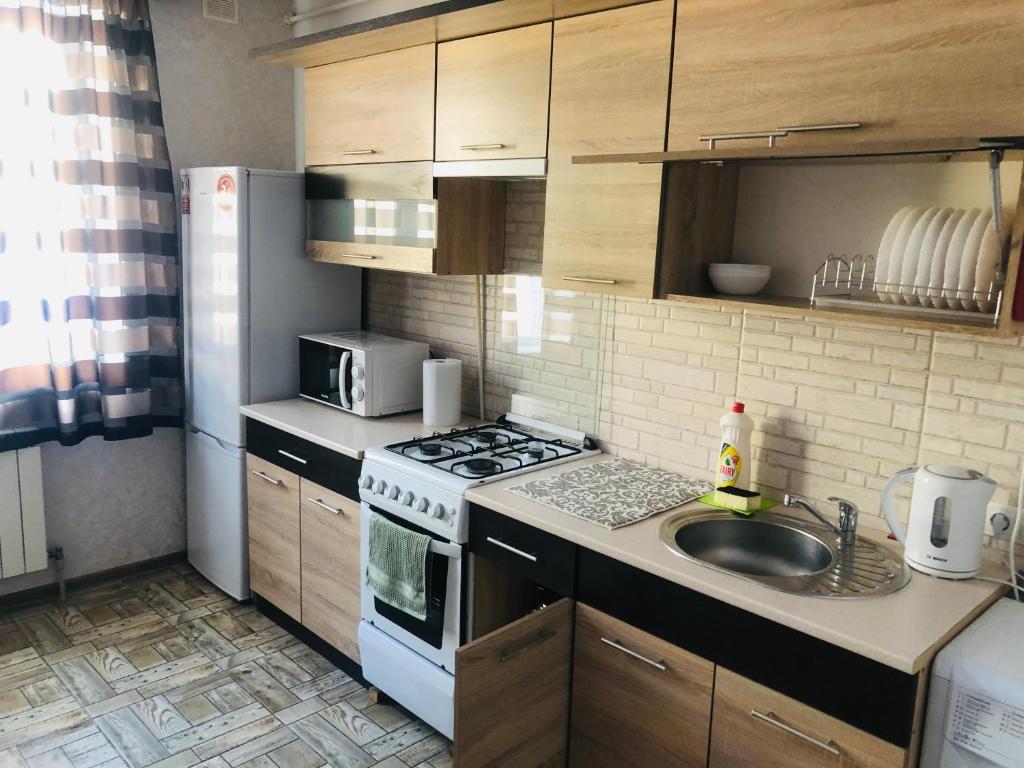 a small kitchen with a stove and a sink at Julia 2 in Umanʼ