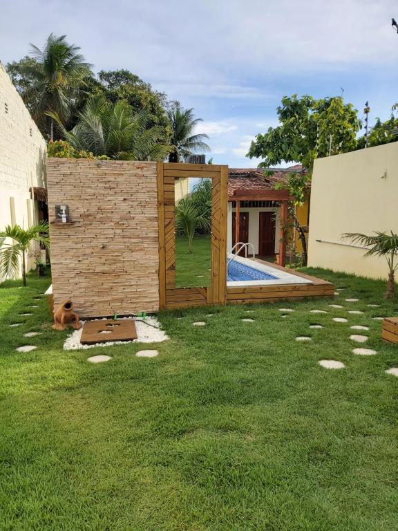 a backyard with a tiny house with a pool at Casa com Piscina in Canavieiras