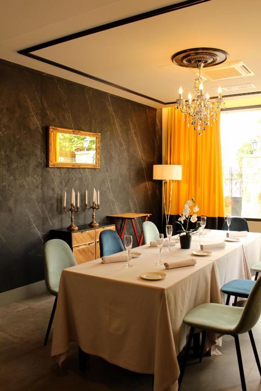 a dining room with a table and chairs and a chandelier at Hotel Gastronómico Torre de Galizano in Galizano