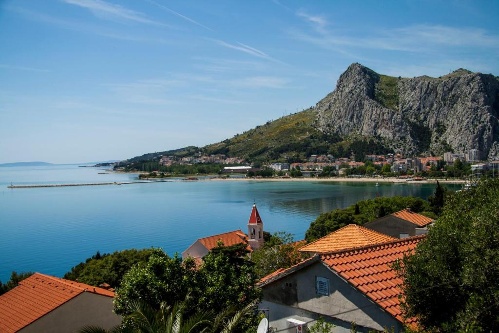 a view of a town on the water with a mountain at Apartments Beautiful View in Omiš