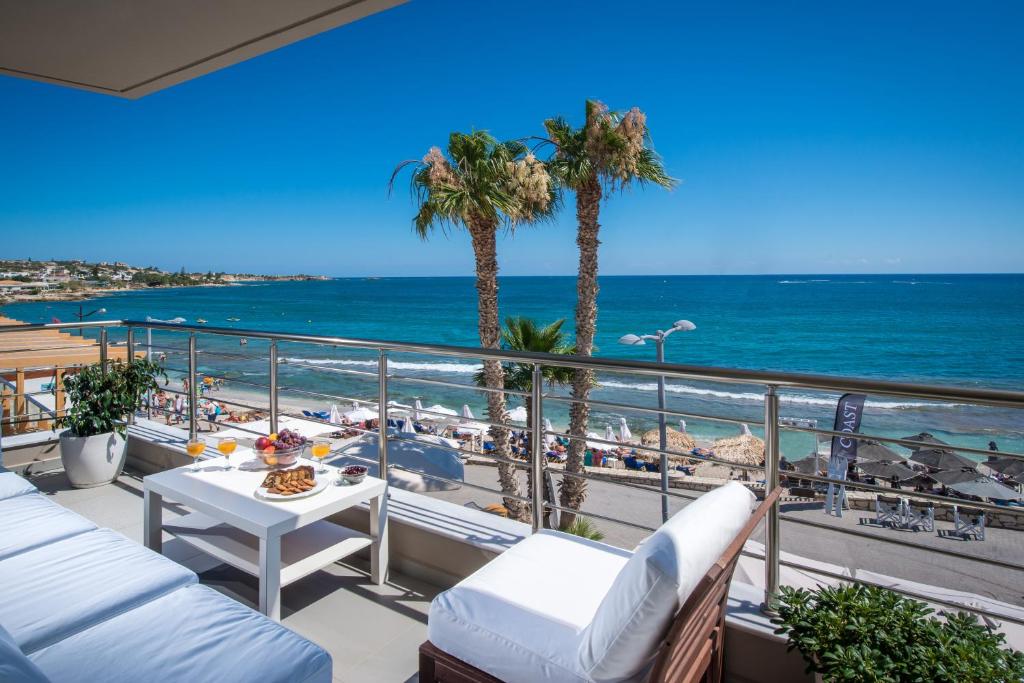 a balcony with a view of the beach and the ocean at Coast Suite-Luxury Central Beach House in Hersonissos