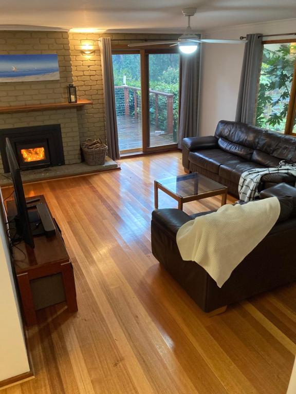 a living room with a couch and a fireplace at Centrum, Red Hill South. in Red Hill